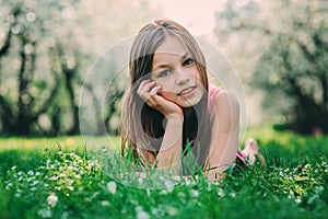 Spring closeup outdoor portrait of adorable 11 years old preteen kid girl