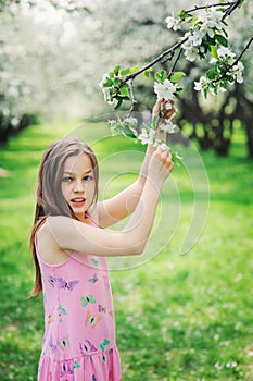 Spring closeup outdoor portrait of adorable 11 years old preteen kid girl