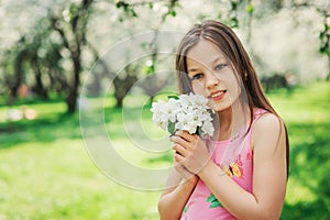 Spring closeup outdoor portrait of adorable 11 years old preteen kid girl