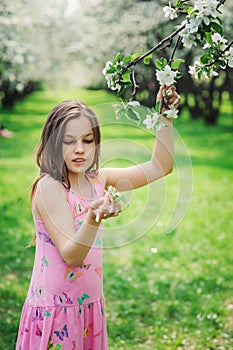 Spring closeup outdoor portrait of adorable 11 years old preteen kid girl