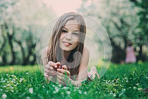 Spring closeup outdoor portrait of adorable 11 years old preteen kid girl