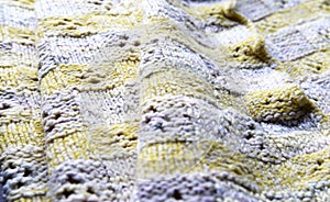 Spring colors texture background from merino knitted blanket, scandinavian minimalism backdrop top view. Abstract yellow