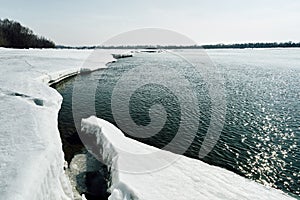 Spring comes in Siberia. Ice crushes on the river, trees stands without leaves photo