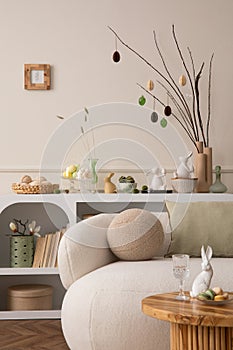 Spring composition of easter living room interior with mock up poster frame, modern sideboard, coffee table easter eggs, round