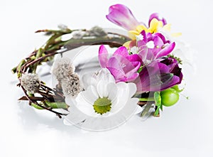 Spring composition with willow twigs wreath and fresh flowers on