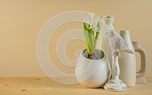 Spring cozy home decor: white vases, white hyacinth and bird figurines