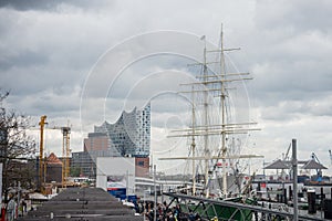 Spring day in april in hamburg hafencity view on elbphilharmony and sailing ship train staion
