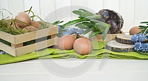 Spring decorative composition. Flowers in a basket and pots of hyacinth, muscari, narcissus.