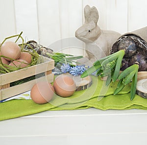 Spring decorative composition. Flowers in a basket and pots of hyacinth, muscari, narcissus.