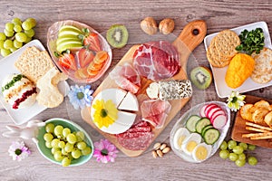 Spring or Easter charcuterie table scene against a wood background