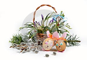 Spring easter composition, decorative rabbits - eggs, on background basket with spring flowers