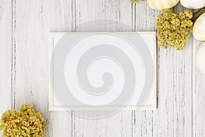 Spring Easter frame with eggs, yellow flowers and copy space, flat lay. Easter mockup, template