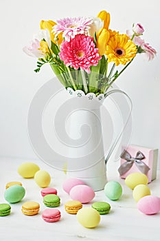 Spring and Easter holiday concept with copy space. Template Easter Greeting Card. Easter eggs and flowers on white background.