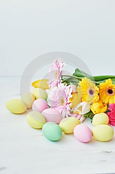 Spring and Easter holiday concept with copy space. Template Easter Greeting Card. Easter eggs and flowers on white background.