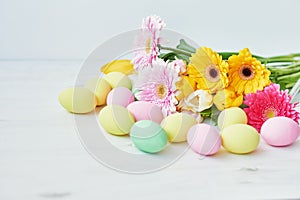 Spring and Easter holiday concept with copy space. Template Easter Greeting Card. Easter eggs and flowers on white background.