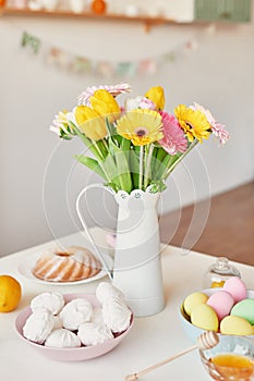 Spring and Easter holiday concept with copy space. Template Easter Greeting Card. Easter eggs and flowers on white background.