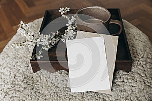 Spring Easter still life. Greeting card, envelope mockup. Cup of coffee. Feminine photo. Floral scene. Blurred cherry