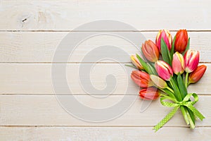 Spring easter tulips in bucket on white vintage background.