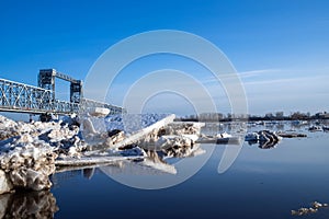 Spring evening in Arkhangelsk. Ice drift on the Severnaya Dvina river. The world`s northernmost drawbridge