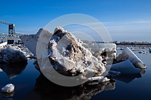 Spring evening in Arkhangelsk. Ice drift on the Severnaya Dvina river. The world`s northernmost drawbridge