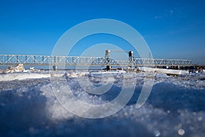 Spring evening in Arkhangelsk. Ice drift on the Severnaya Dvina river. The world`s northernmost drawbridge