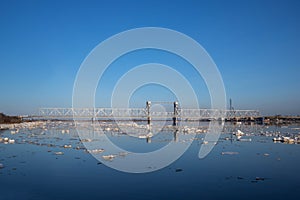 Spring evening in Arkhangelsk. Ice drift on the Severnaya Dvina river. The world`s northernmost drawbridge