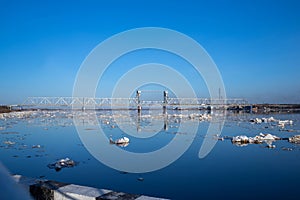 Spring evening in Arkhangelsk. Ice drift on the Severnaya Dvina river. The world`s northernmost drawbridge