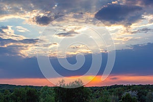 On a spring evening, the sun sets behind the mountains of Slovakia. Dramatic sunset, spring landscape.