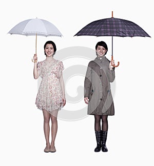 Spring and fall, smiling young women with umbrella, studio shot