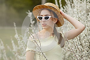 Spring fashion girl outdoor portrait in bloom . Beauty Romantic woman in flowers. Beautiful Woman Enjoying Nature