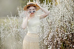 Spring fashion girl outdoor portrait in bloom . Beauty Romantic woman in flowers. Beautiful Woman Enjoying Nature