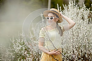 Spring fashion girl outdoor portrait in bloom . Beauty Romantic woman in flowers. Beautiful Woman Enjoying Nature