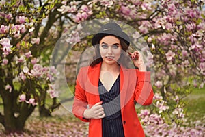 Spring fashion girl outdoors portrait in blooming trees. Beauty Romantic woman in flowers. Sensual Lady enjoying Nature.