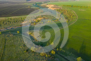 Spring fields, meadows, ravines at sunset from the quadrocopter