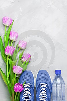 Spring flatlay sports composition with blue sneakers and purple