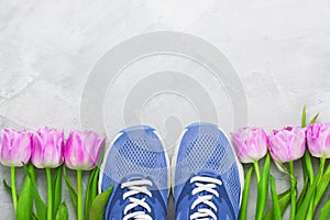 Spring flatlay sports composition with blue sneakers and purple