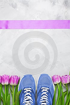 Spring flatlay sports composition with blue sneakers and purple