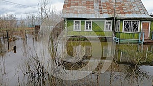 The spring the flood of the river after the rain flooding the garden and the house in the flood