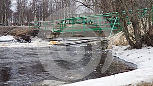 Spring flood. Rushing water in the river. Dark ferrous water rushes in the stream. Karelia, Lososinka River in spring