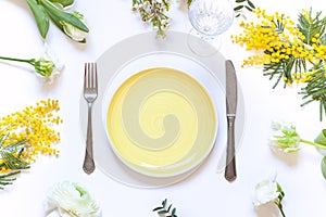 Spring floral table settings with spring flowers. Top view empty plate.