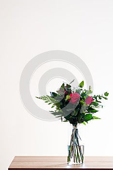 Spring flower bouquet on white background. Colorful vintage flower decoration. Tulips and roses in floreal bouquet