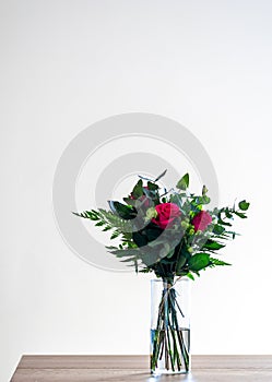 Spring flower bouquet on white background. Colorful vintage flower decoration. Tulips and roses in floreal bouquet