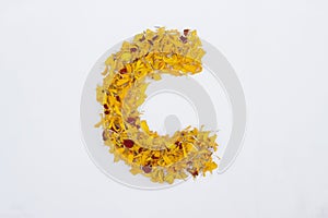 Spring Flower Letter concept of Marigold petal. Marigold petal alphabet isolated on white background. Letter C concept Logo photo