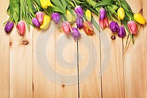 Spring Flowers bunch at wood floor texture. Beautiful Tulips bou