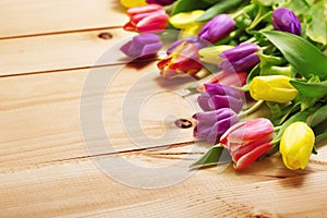 Spring Flowers bunch at wood floor texture. Beautiful Tulips bou