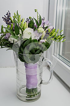 Spring flowers buttercup ranunculus, lavender in glass on white Background. Pastel colors. Holiday gift. Rustic style, still life.