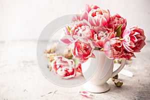 Spring flowers and Easter decorations on shabby chic background