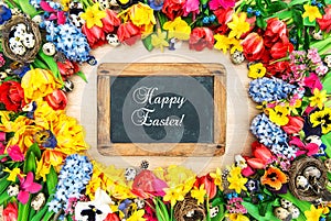 Spring flowers and easter eggs. Holidays background chalkboard