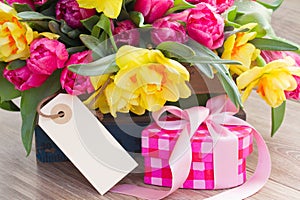 Spring flowers with gift box and empty tag