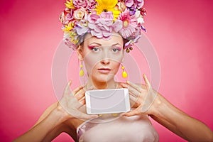 Spring flowers girl is holding smartphone in hands